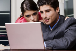 man and woman on a laptop